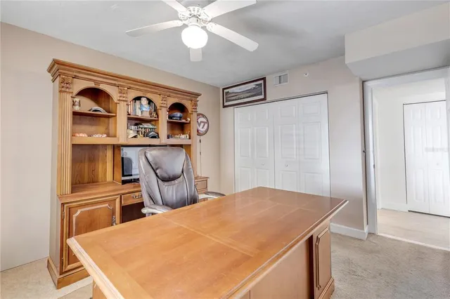 a view of kitchen with refrigerator and cabinets