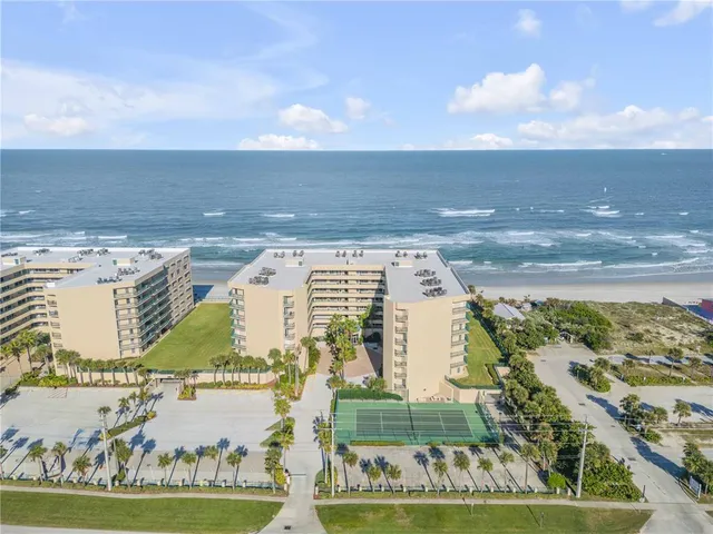 a kitchen with stainless steel appliances granite countertop a stove a sink a dining table and chairs with wooden floor