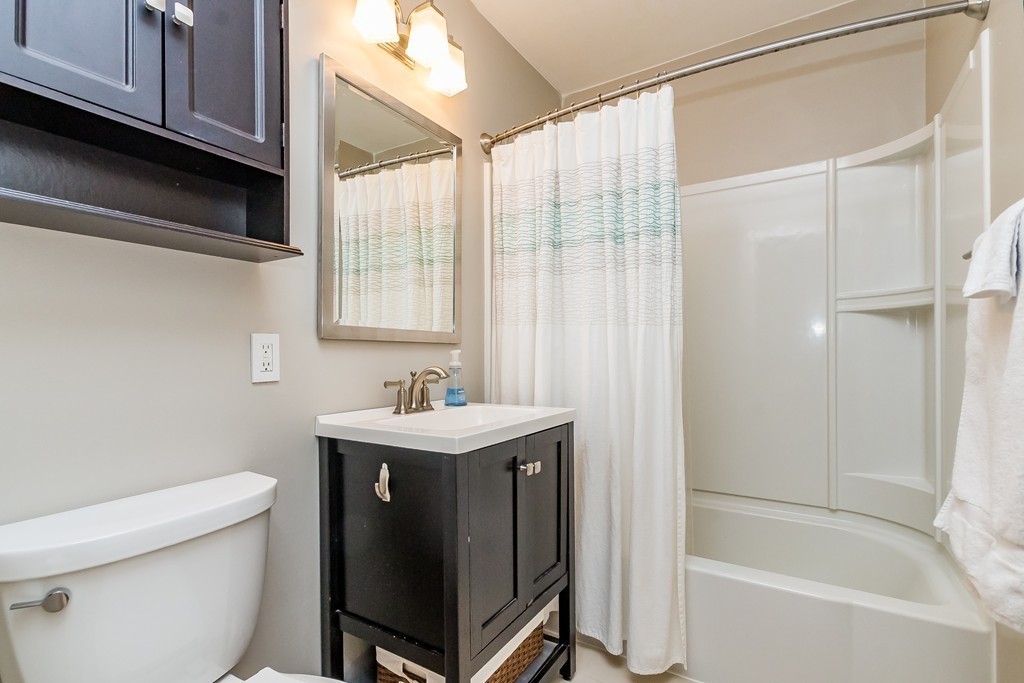 95 Anderer Lane, Unit 4 Boston, MA 02132 - Photo 11 of 22 a bathroom with a sink a toilet and shower