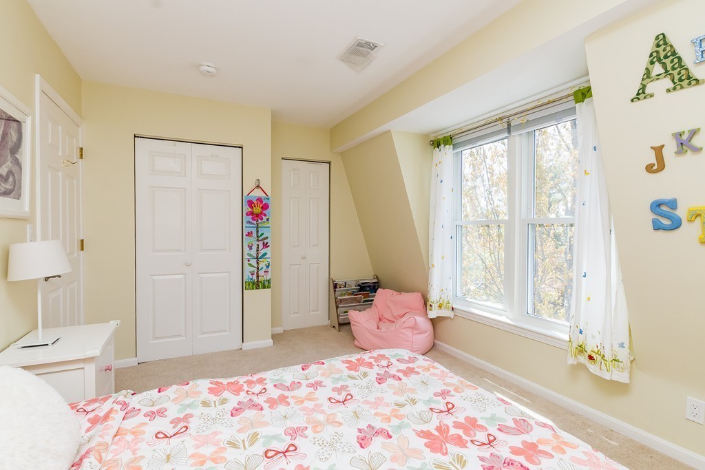 95 Anderer Lane, Unit 4 Boston, MA 02132 - Photo 13 of 22 a bedroom with a bed and wooden floor