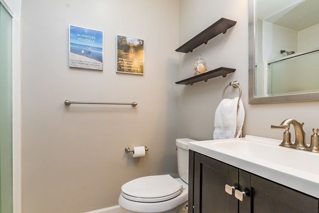 95 Anderer Lane, Unit 4 Boston, MA 02132 - Photo 14 of 22 a bathroom with a sink a toilet and mirror