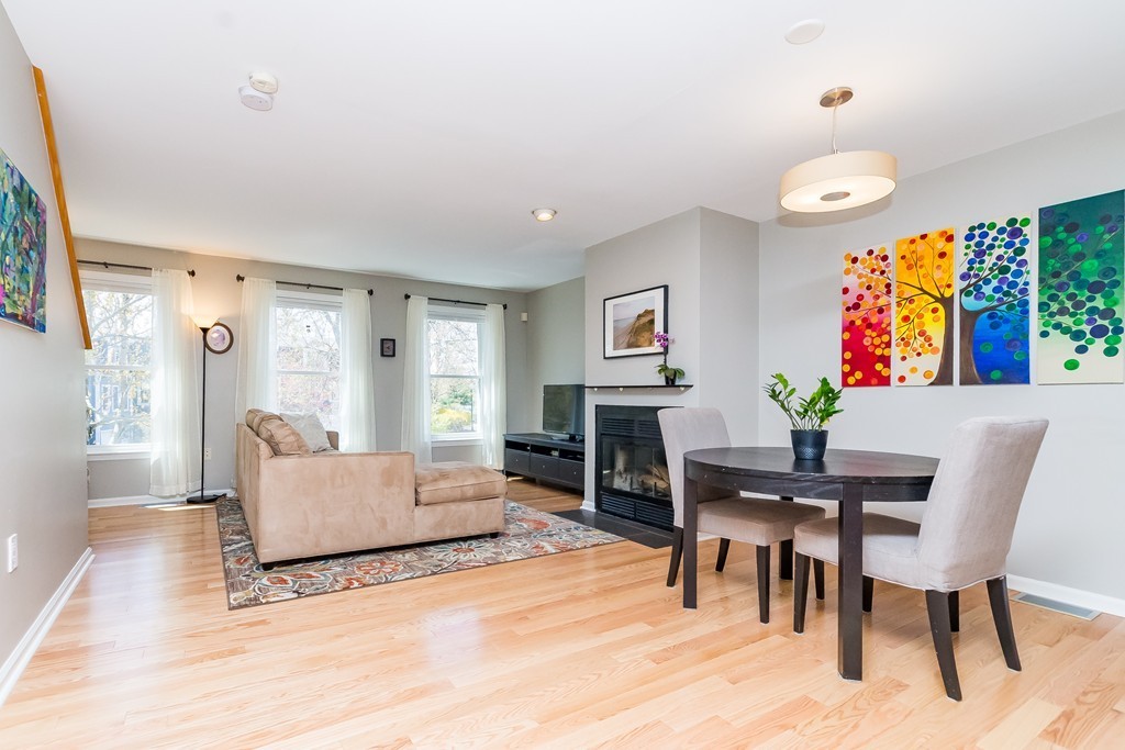 95 Anderer Lane, Unit 4 Boston, MA 02132 - Photo 2 of 22 a living room with furniture a fireplace and a table