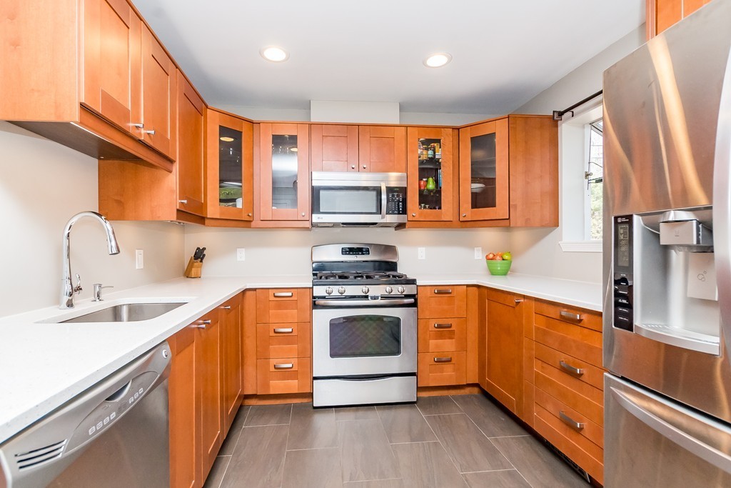 95 Anderer Lane, Unit 4 Boston, MA 02132 - Photo 3 of 22 a kitchen with stainless steel appliances granite countertop a stove a sink and a refrigerator