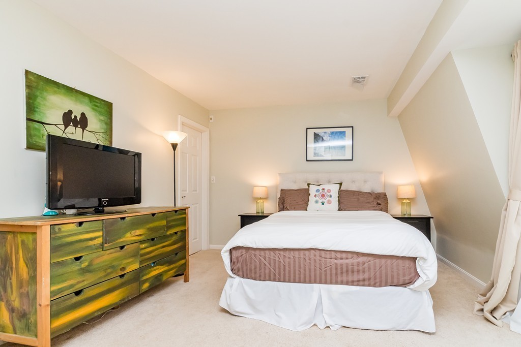 95 Anderer Lane, Unit 4 Boston, MA 02132 - Photo 9 of 22 a bedroom with a bed and a flat screen tv
