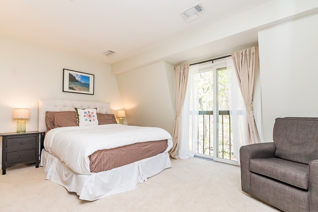 95 Anderer Lane, Unit 4 Boston, MA 02132 - Photo 10 of 22 a spacious bedroom with a bed and a couch