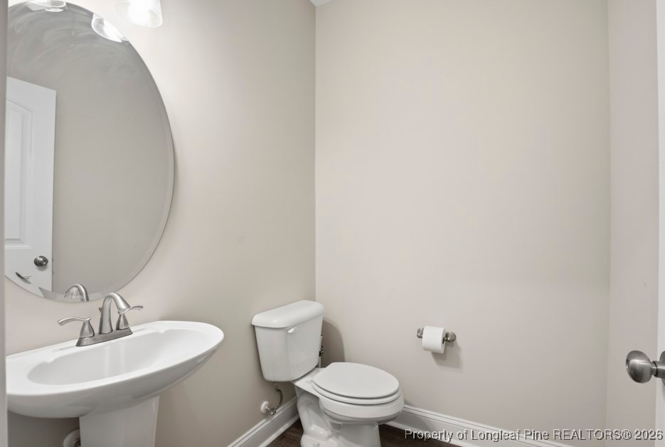 4830 Quiet Pine Road Fayetteville, NC 28314 - Photo 22 of 50 a bathroom with a sink a toilet and a mirror
