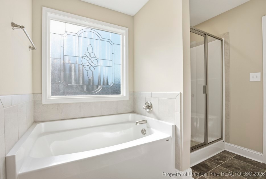 4830 Quiet Pine Road Fayetteville, NC 28314 - Photo 32 of 50 a white bath tub sitting next to a window