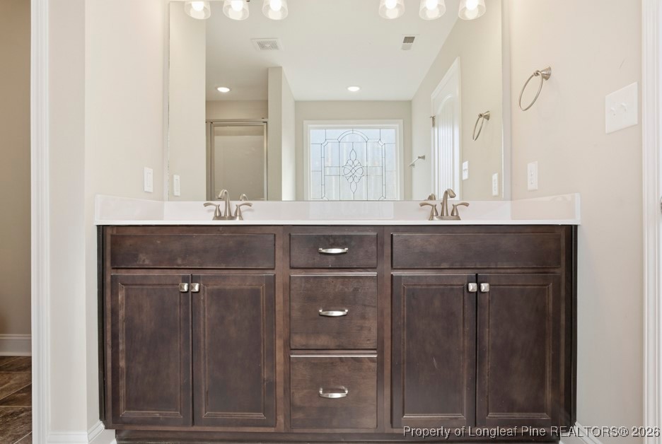 4830 Quiet Pine Road Fayetteville, NC 28314 - Photo 33 of 50 a bathroom with a sink vanity and mirror