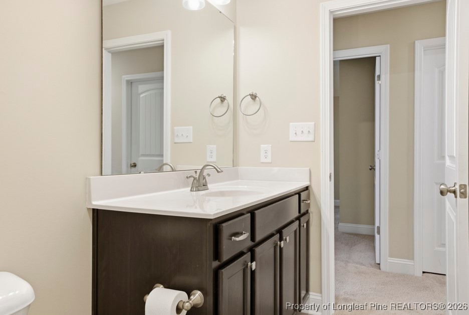 4830 Quiet Pine Road Fayetteville, NC 28314 - Photo 44 of 50 a bathroom with a sink a toilet and mirror