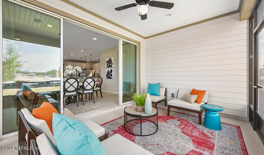 11463 Eagle Vail Court Jacksonville, FL 32221 - Photo 8 of 10 a living room with furniture a rug and a floor to ceiling window