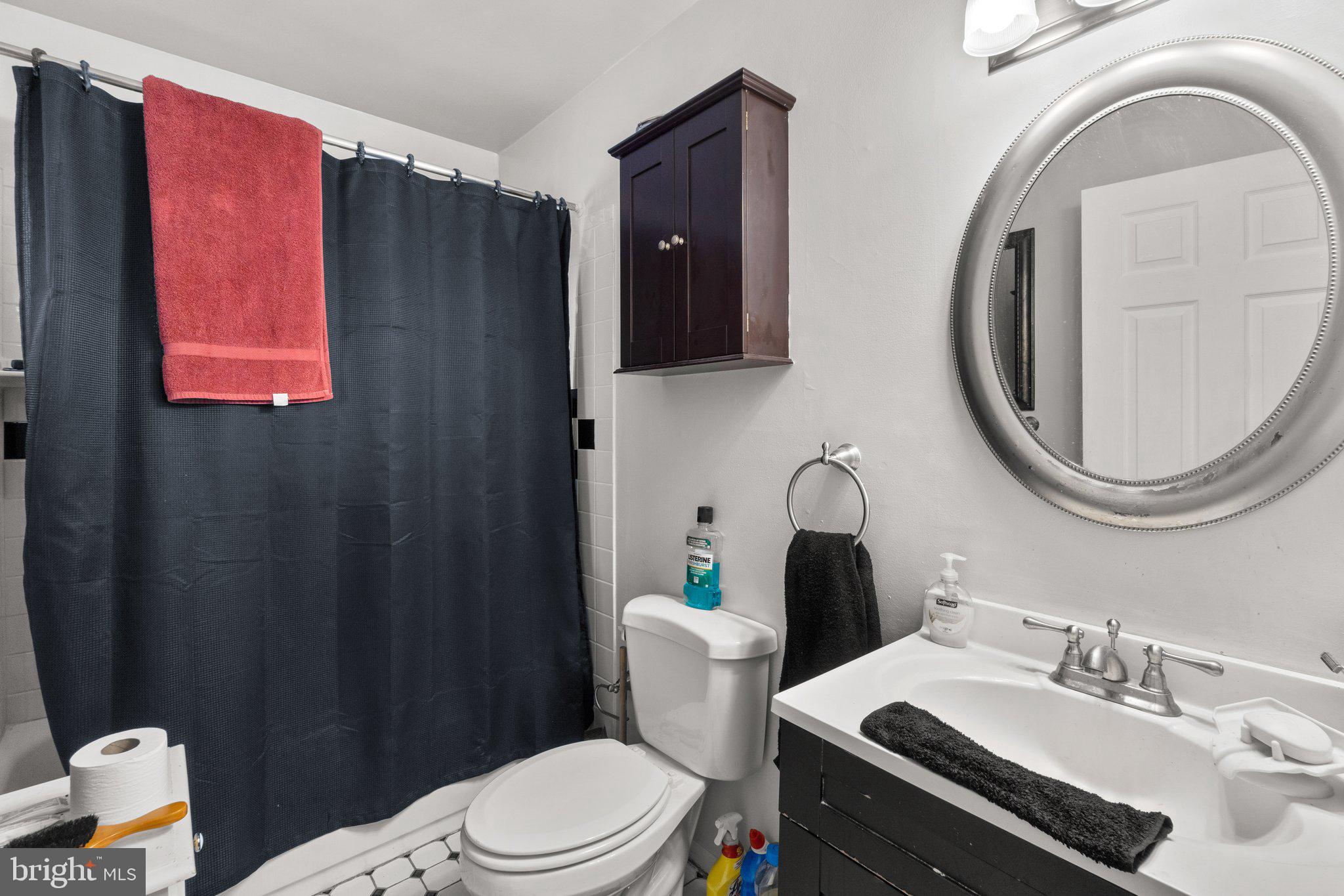 3928 Rolling Rd., Unit C9 Pikesville, MD 21208 - Photo 18 of 23 a bathroom with a sink vanity mirror and toilet