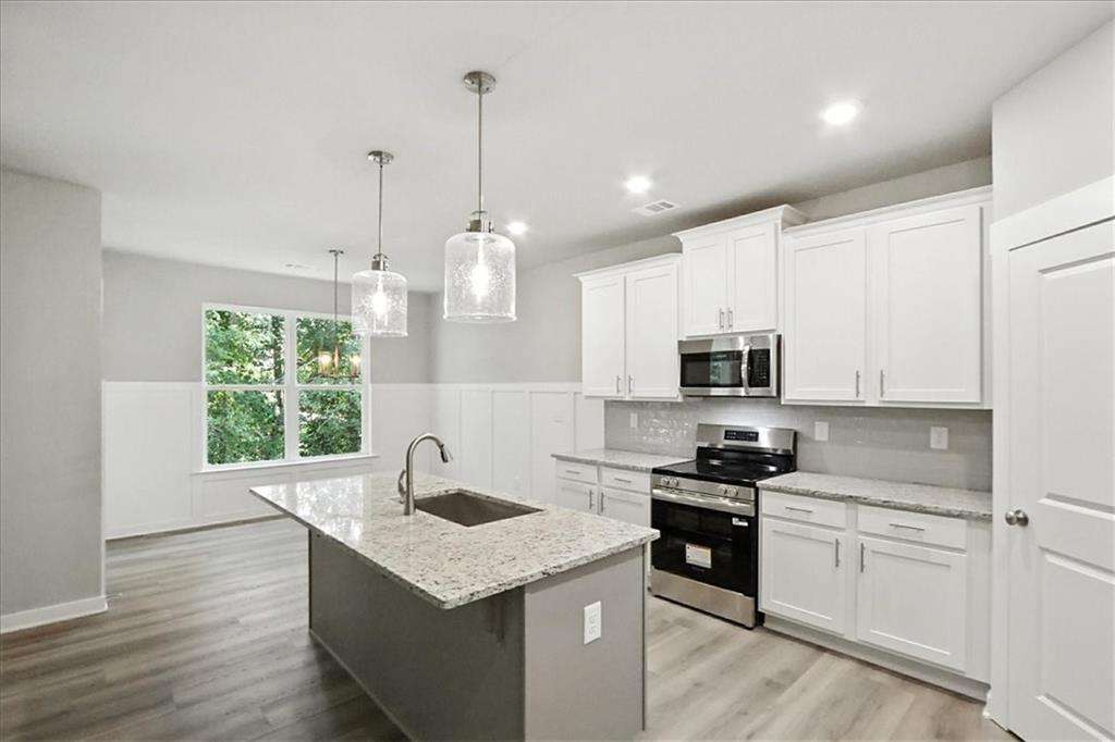 4022 Links Boulevard Jefferson, GA 30549 - Photo 11 of 54 a kitchen with granite countertop a sink a counter space appliances and cabinets