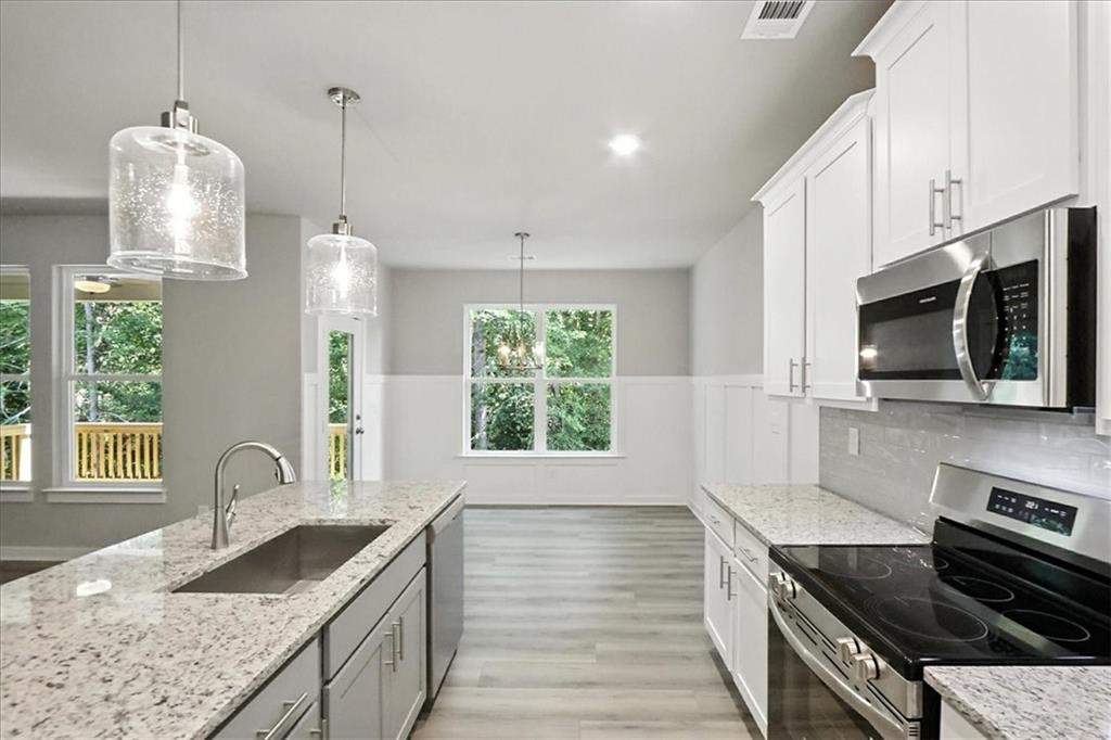 4022 Links Boulevard Jefferson, GA 30549 - Photo 14 of 54 a kitchen with granite countertop a sink a counter space appliances and cabinets
