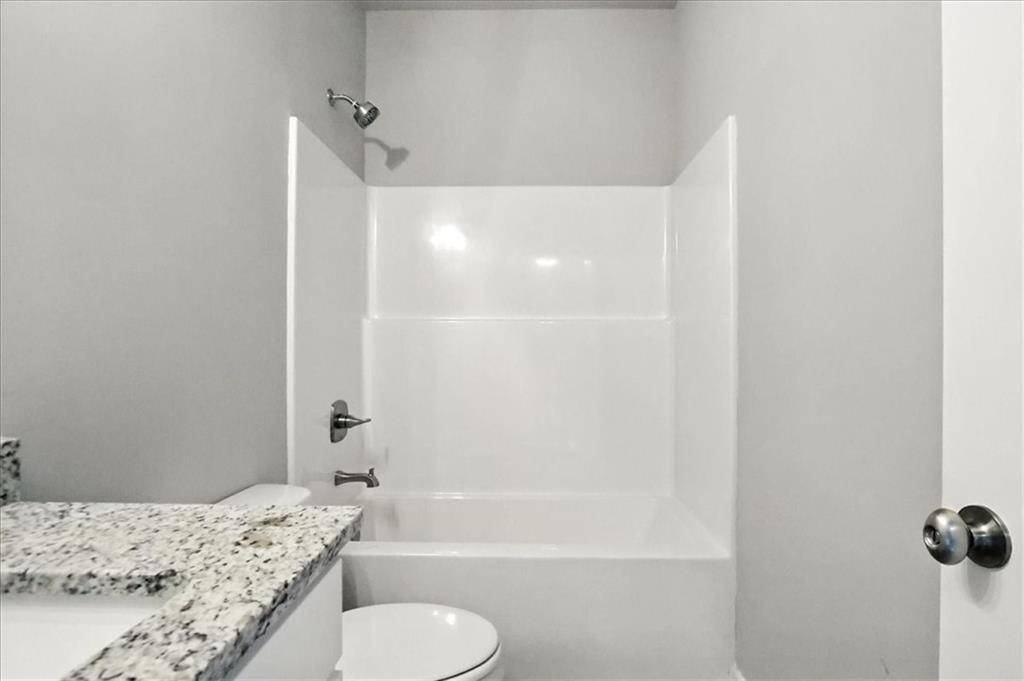 4022 Links Boulevard Jefferson, GA 30549 - Photo 24 of 54 a bathroom with a granite countertop sink toilet and shower