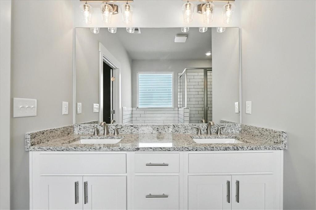 4022 Links Boulevard Jefferson, GA 30549 - Photo 31 of 54 a bathroom with sinks granite vanity and a mirror