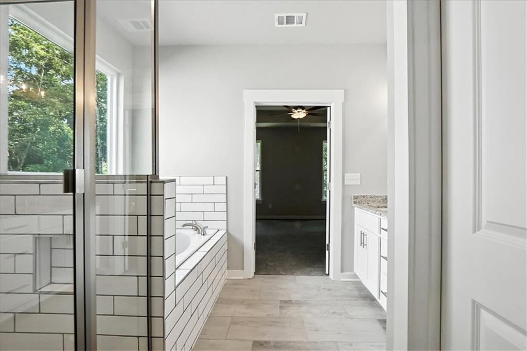 4022 Links Boulevard Jefferson, GA 30549 - Photo 32 of 54 a bathroom with a bathtub and shower