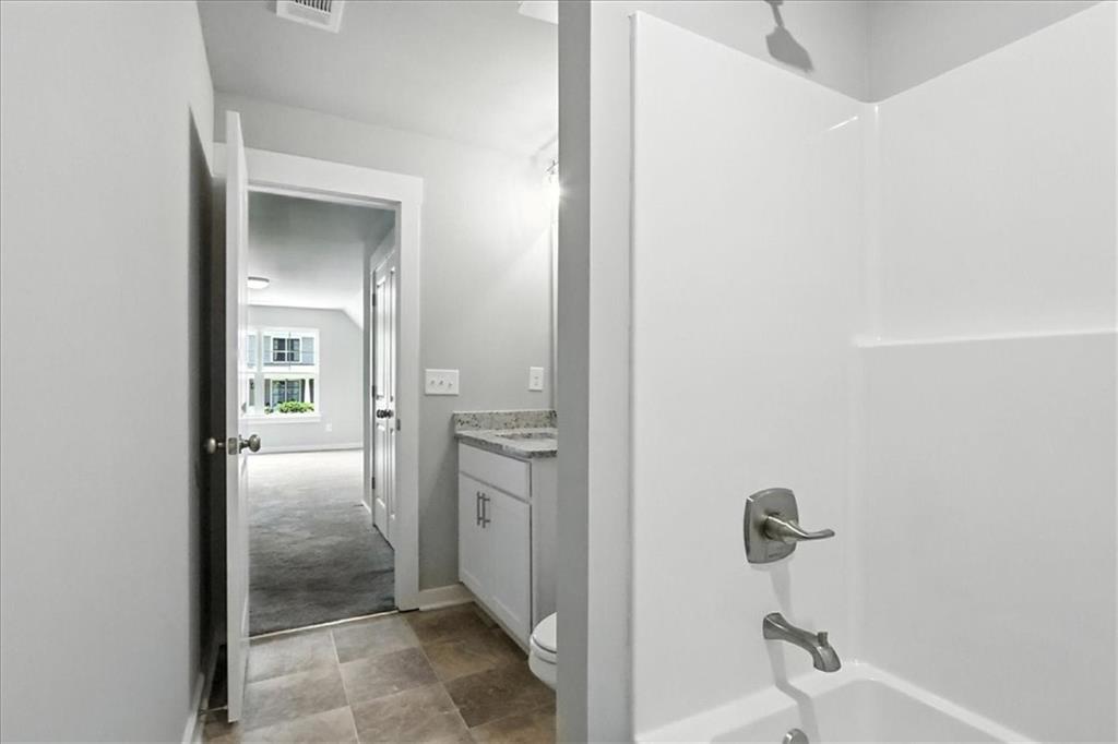 4022 Links Boulevard Jefferson, GA 30549 - Photo 42 of 54 a bathroom with a granite countertop sink and mirror