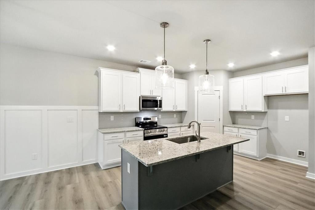 4022 Links Boulevard Jefferson, GA 30549 - Photo 10 of 54 a kitchen with a sink a stove a refrigerator and cabinets