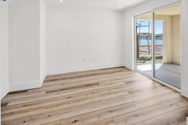 a view of room with wooden floor and fan