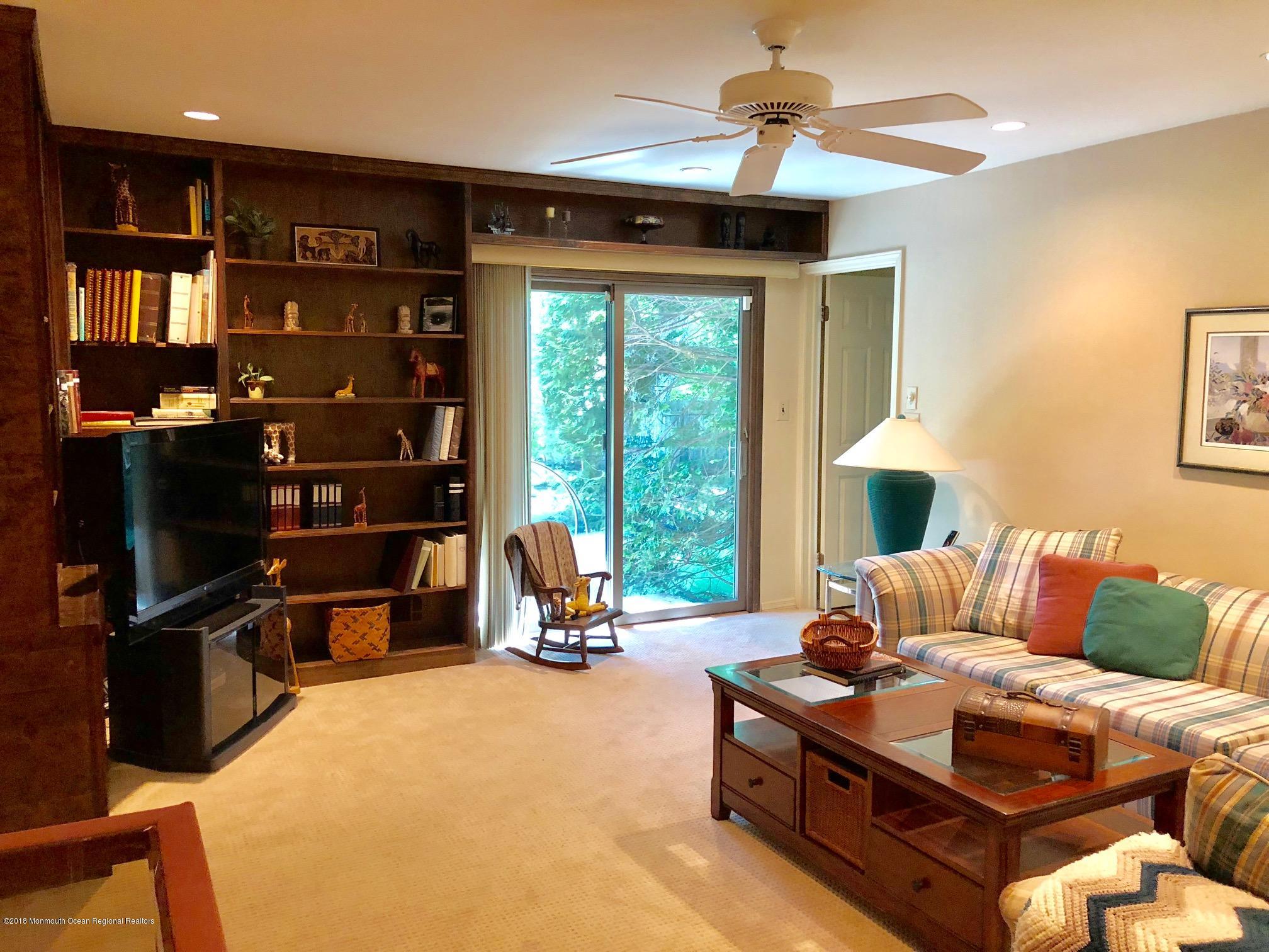 3 Regina Road Morganville, NJ 07751 - Photo 10 of 22 BUILT-IN BOOKCASE & SLIDER IN DEN