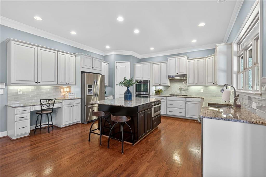 340 Scott Farm Drive Powder Springs, GA 30127 - Photo 16 of 59 a kitchen with a sink a counter top space stainless steel appliances and cabinets