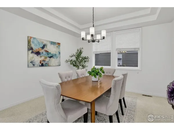 a view of a dining room with furniture and chandelier