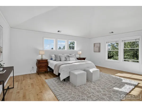 a spacious bedroom with a bed and a window