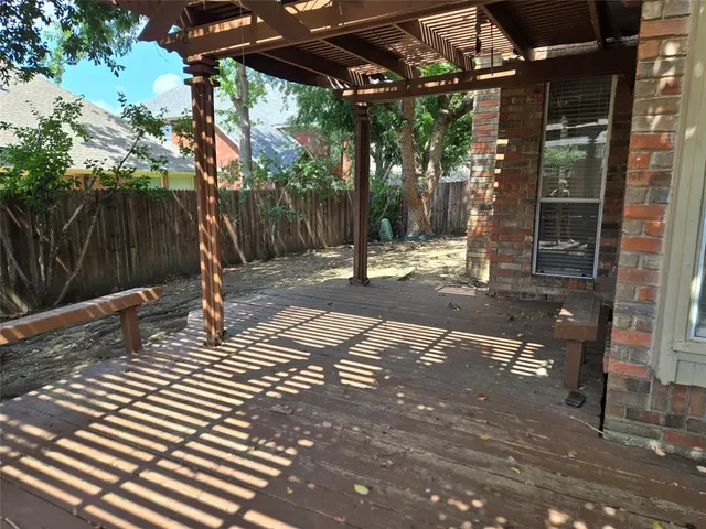 a backyard of a house with barbeque oven table and chairs