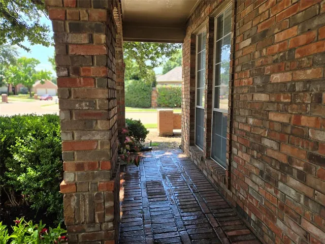a pathway of a house with a yard