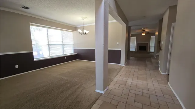 an empty room with windows and entrance