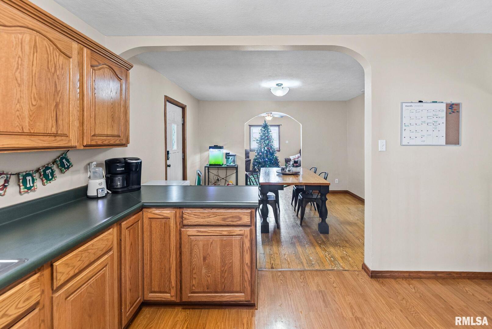 7302 Hoffman Road Centralia, IL 62801 - Photo 20 of 39 a kitchen with stainless steel appliances granite countertop dining table chairs and a refrigerator