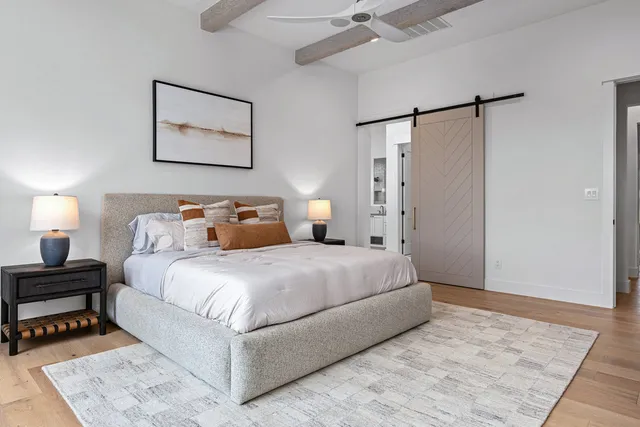 a kitchen with white cabinets and sink