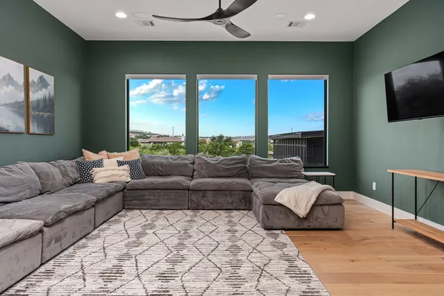 a living room with a couch and a potted plant