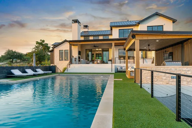 a front view of a house with swimming pool having outdoor seating