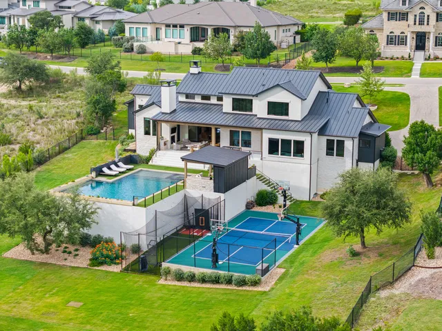 an aerial view of a house with garden space and street view