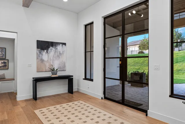 a view of front door with a potted plant and a window