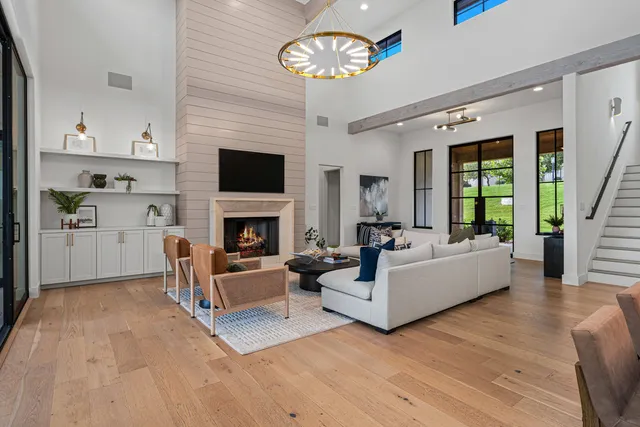a living room with furniture fireplace and flat screen tv
