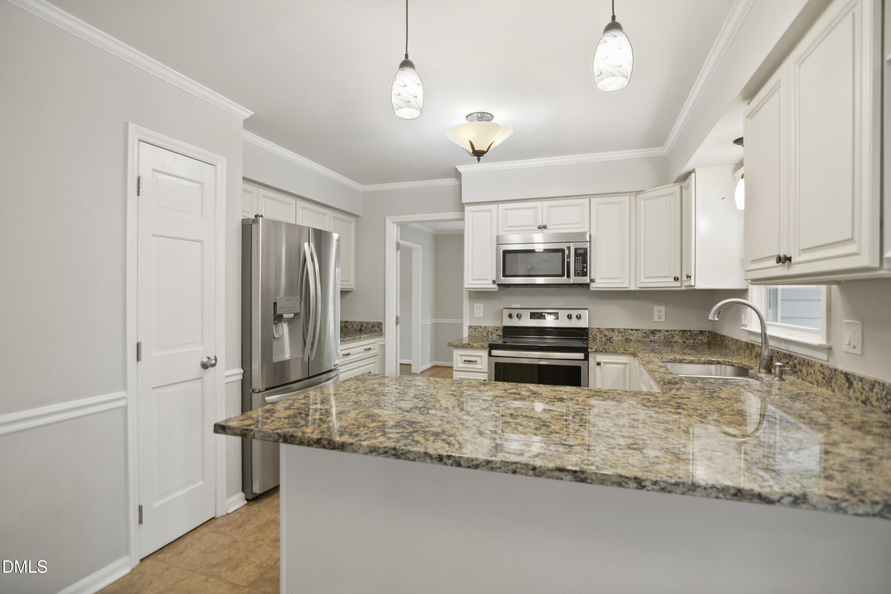 2704 Smokey Ridge Road Raleigh, NC 27613 - Photo 12 of 27 a kitchen with stainless steel appliances granite countertop a stove a sink and a refrigerator