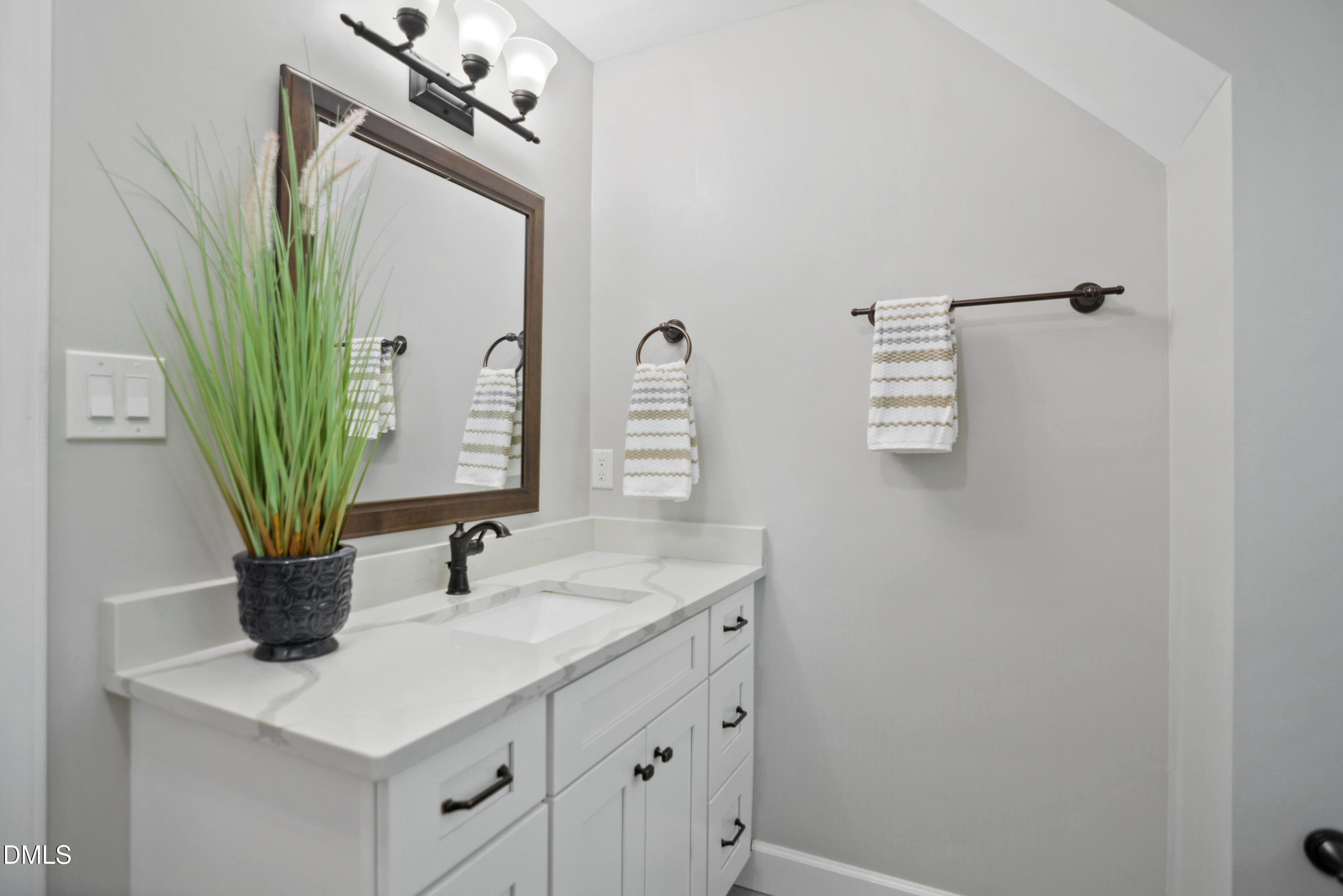 2704 Smokey Ridge Road Raleigh, NC 27613 - Photo 23 of 27 a bathroom with a sink a mirror and vanity