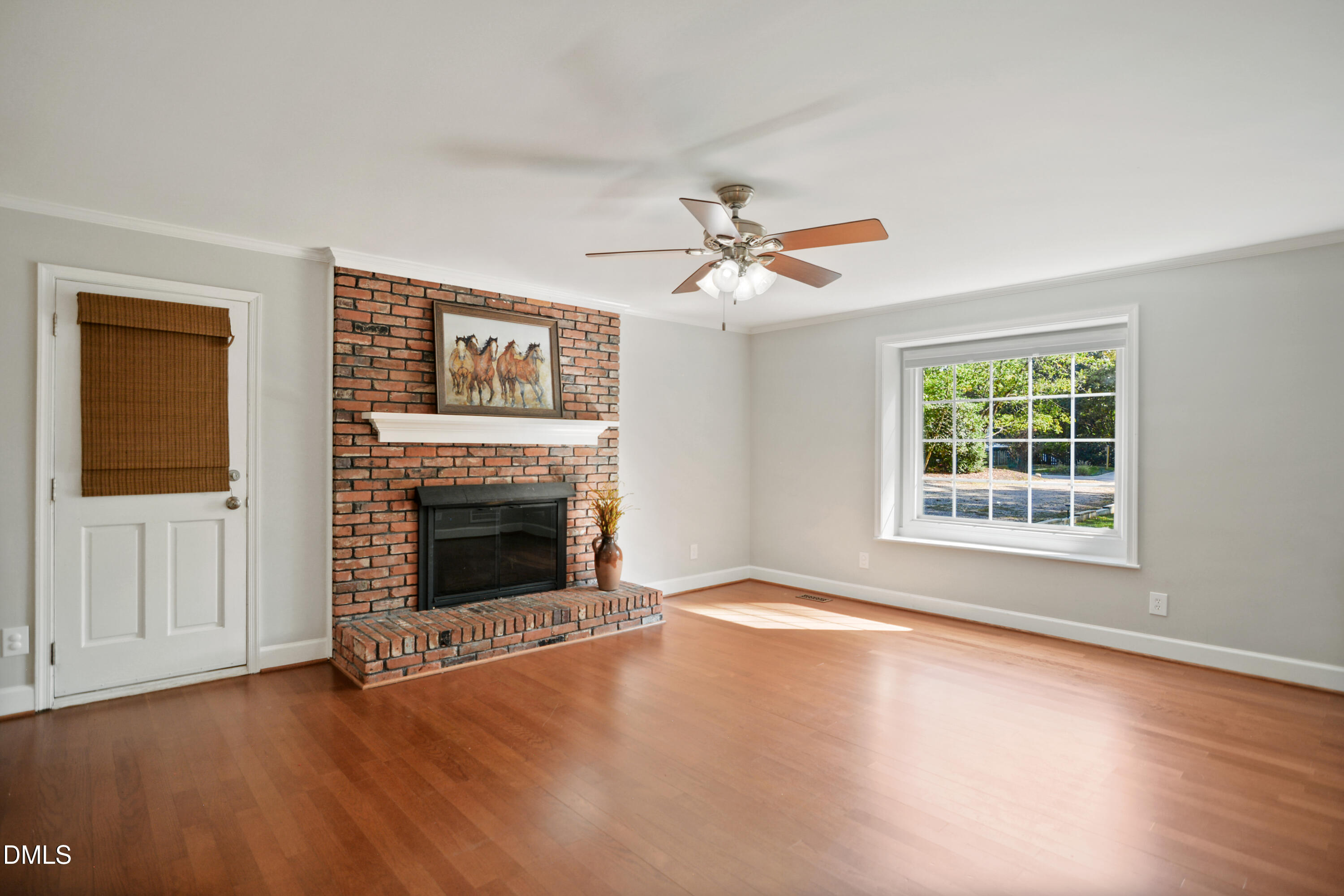 2704 Smokey Ridge Road Raleigh, NC 27613 - Photo 9 of 27 wooden floor fireplace and windows in an empty room