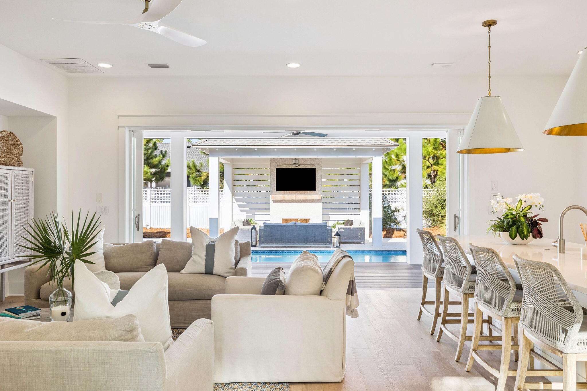 a living room with furniture flat screen tv and a large window