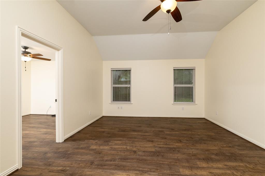 405 Kimbrough Road Azle, TX 76020 - Photo 16 of 39 a view of an empty room with wooden floor and a window
