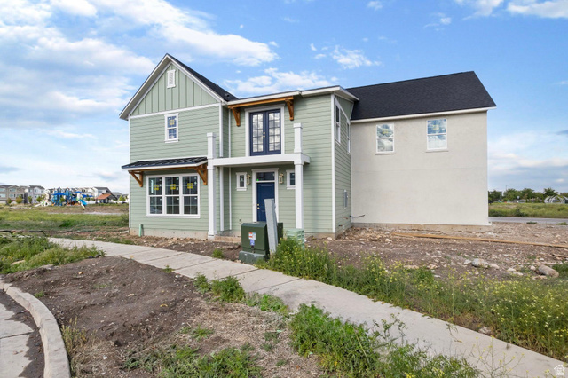 720 South Harrison Drive Springville, UT 84663 - Photo 11 of 14 Two-story residence featuring green vertical and horizontal siding with contrasting light-toned stucco