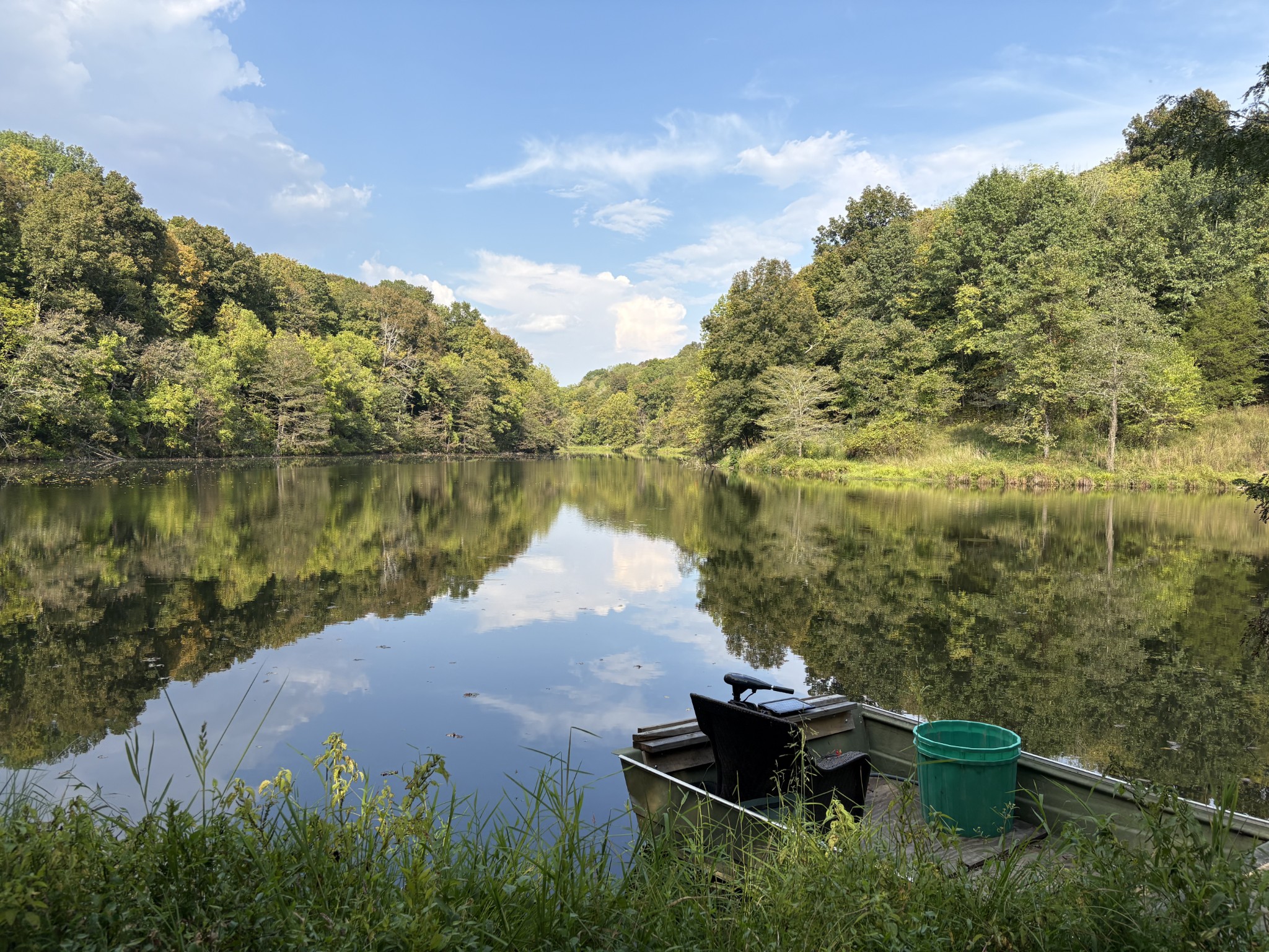 a view of a lake with a yard and mountain view