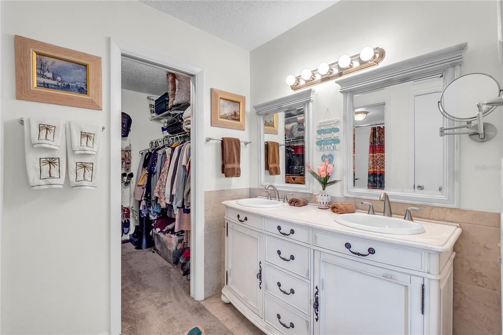 12200 Vonn Road, Unit 2206 Largo, FL 33774 - Photo 36 of 60 a bathroom with a double vanity sink and a mirror