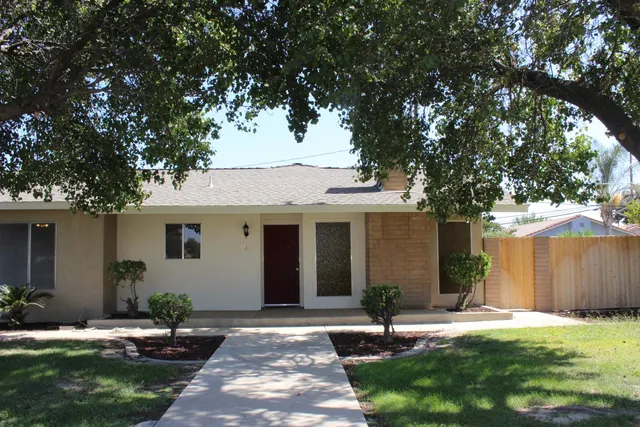 a backyard of a house with yard and outdoor seating