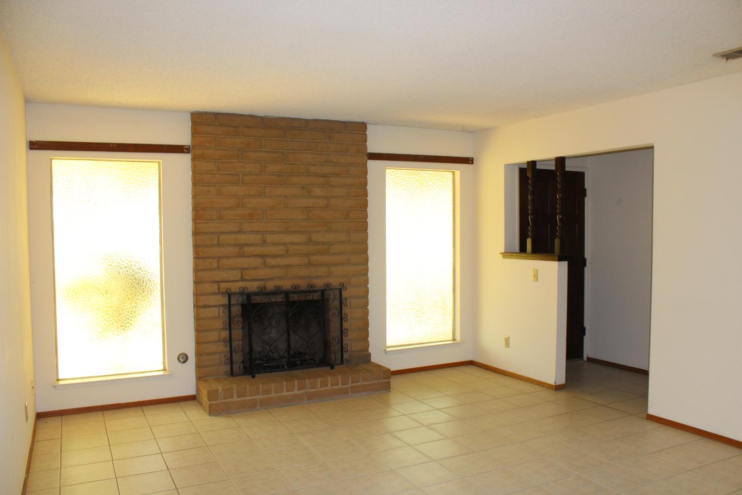 1985 Lynn Lane Hanford, CA 93230 - Photo 3 of 11 a view of an empty room with a fireplace and a window