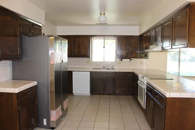 a kitchen with a sink stove and refrigerator