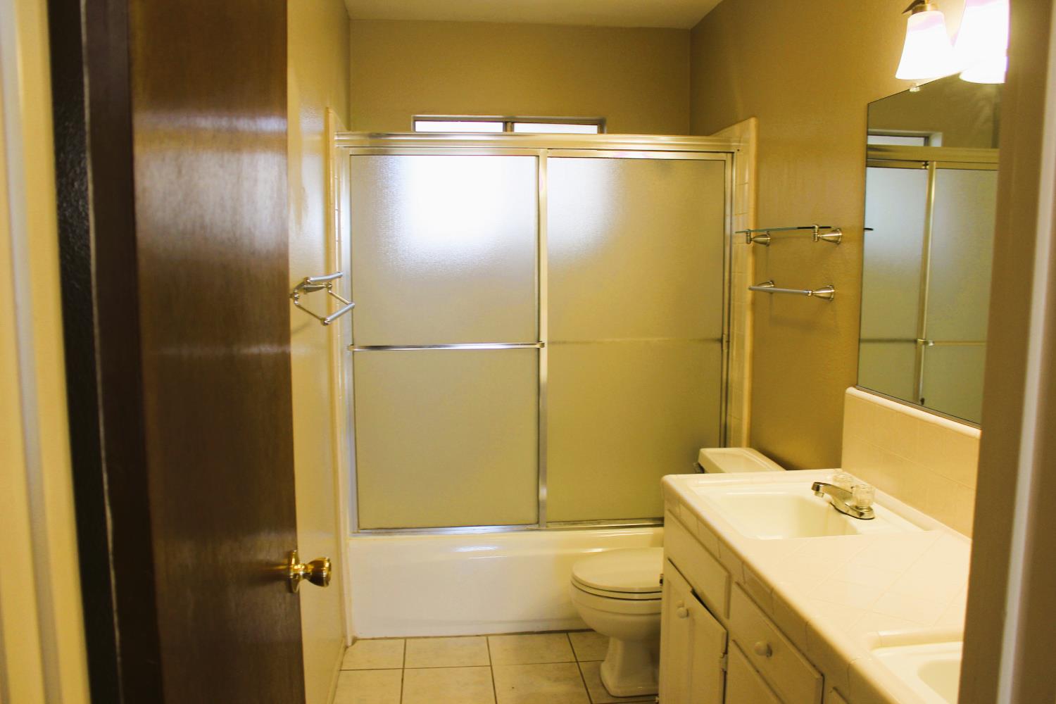 1985 Lynn Lane Hanford, CA 93230 - Photo 7 of 11 a bathroom with a sink a toilet and shower