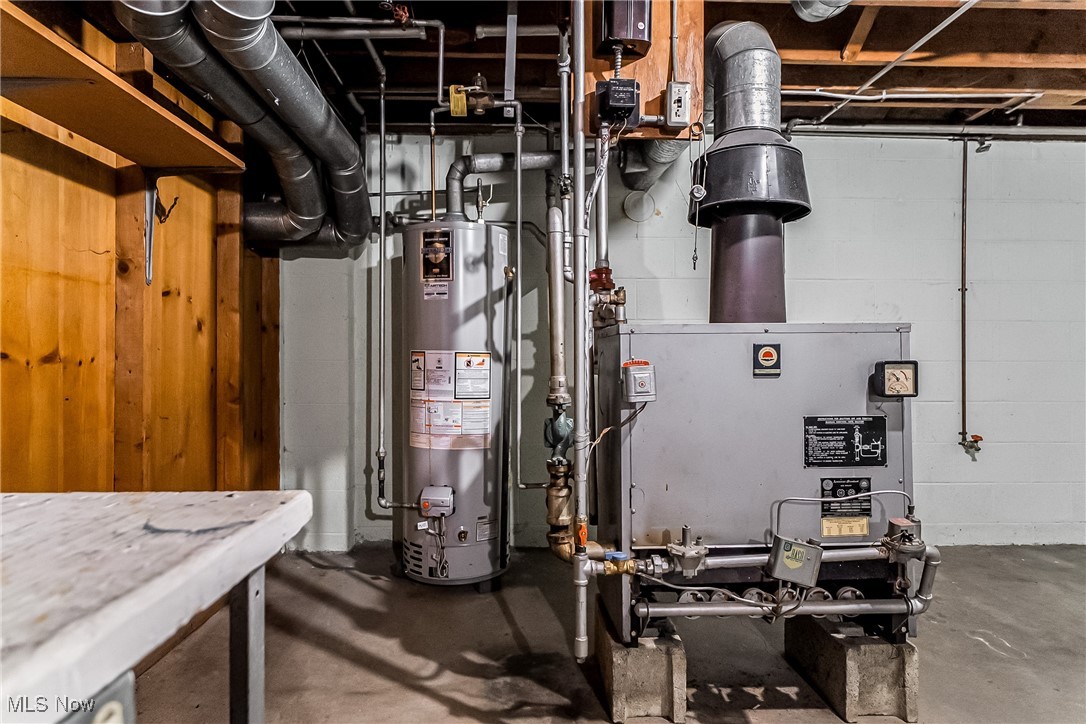 550 Cooper Foster Park Road Lorain, OH 44053 - Photo 40 of 50 Utility room featuring gas water heater and a heating unit